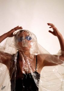 Woman wrapped in plastic during art performance